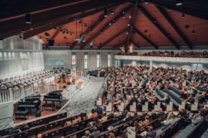A large congregation attending a conference in a modern church setting.